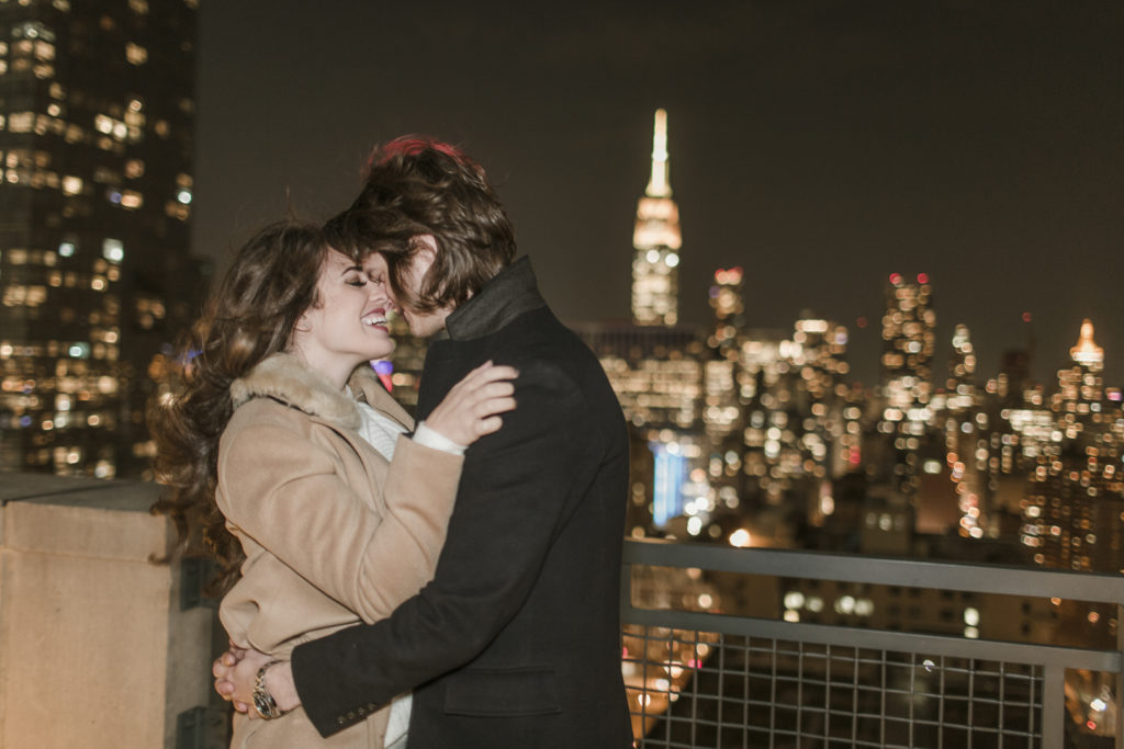 Instagram influencer couple kissing after their engagement on a NYC rooftop