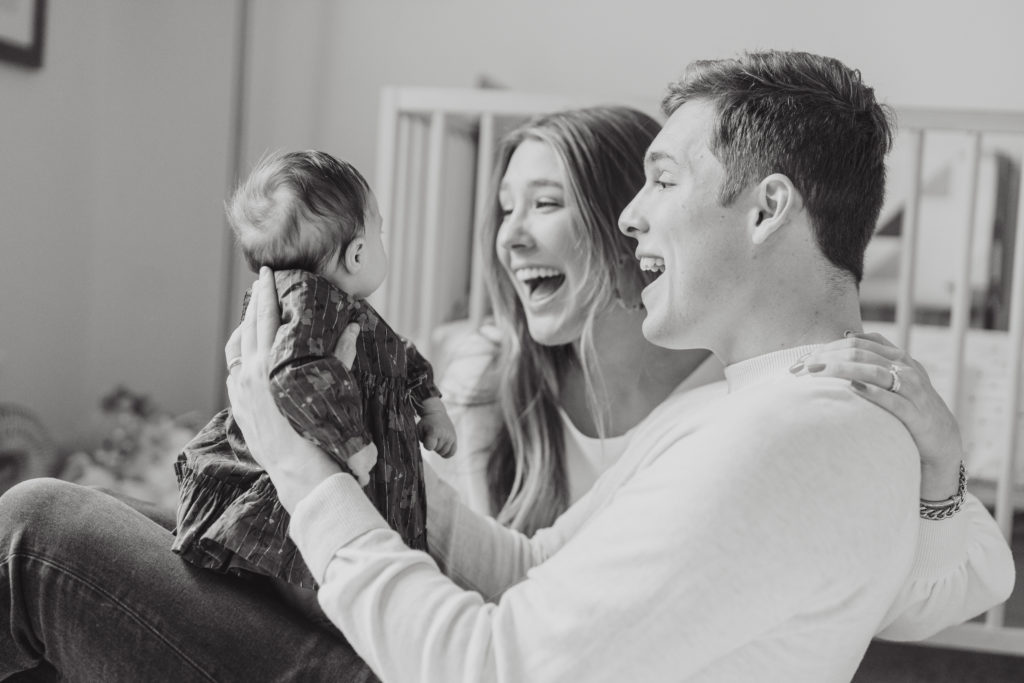 intimate family portraits of a mother, father, and newborn baby