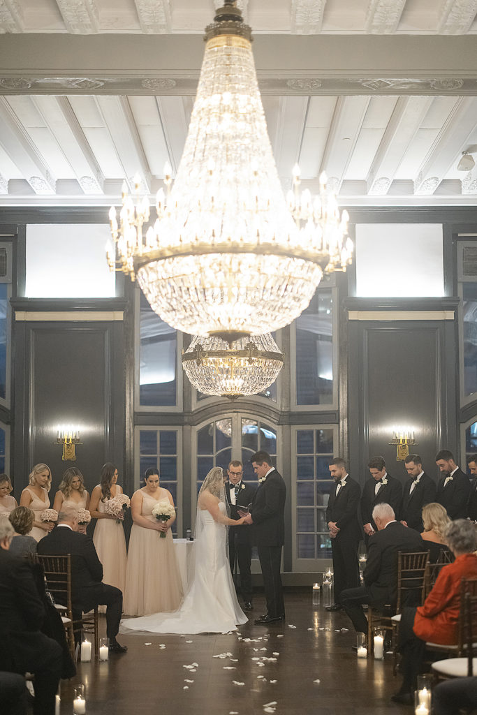 Chicago Athletic Association Wedding of the bride and groom during their ballroom ceremony with huge chandelier