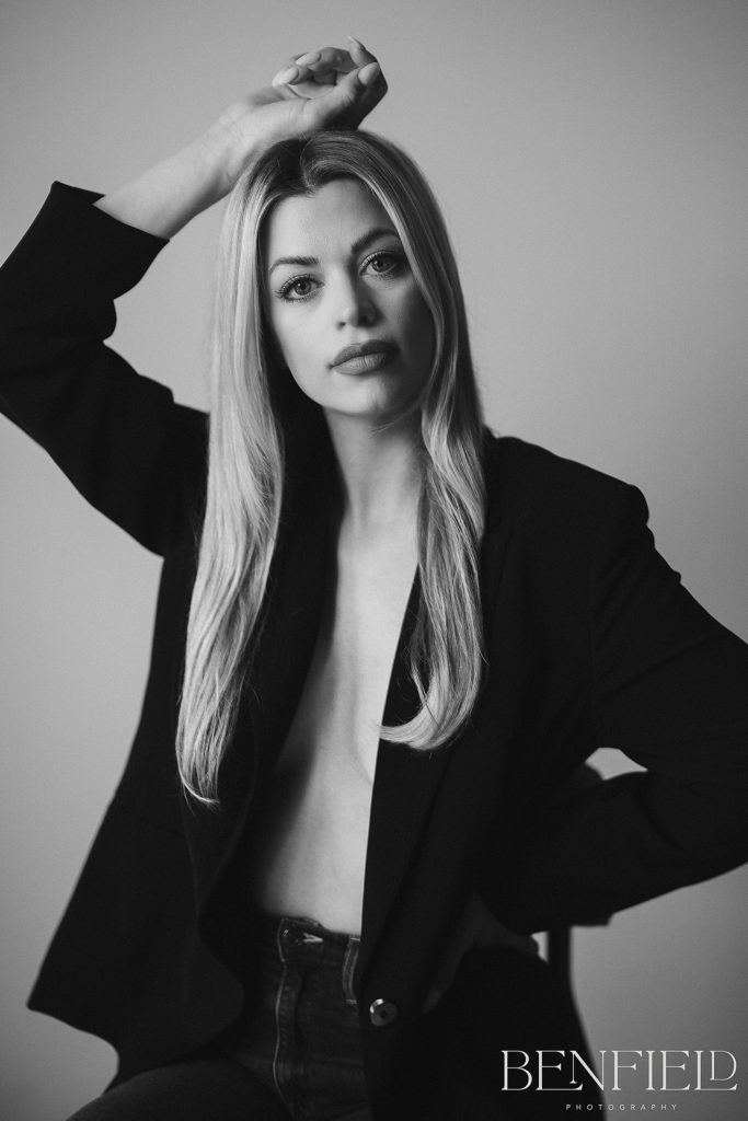 NWA Model Photographer captured black and white of model wearing only a suit jacket (nude underneath)