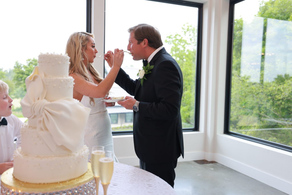Osage House Real Wedding couple eating wedding cake