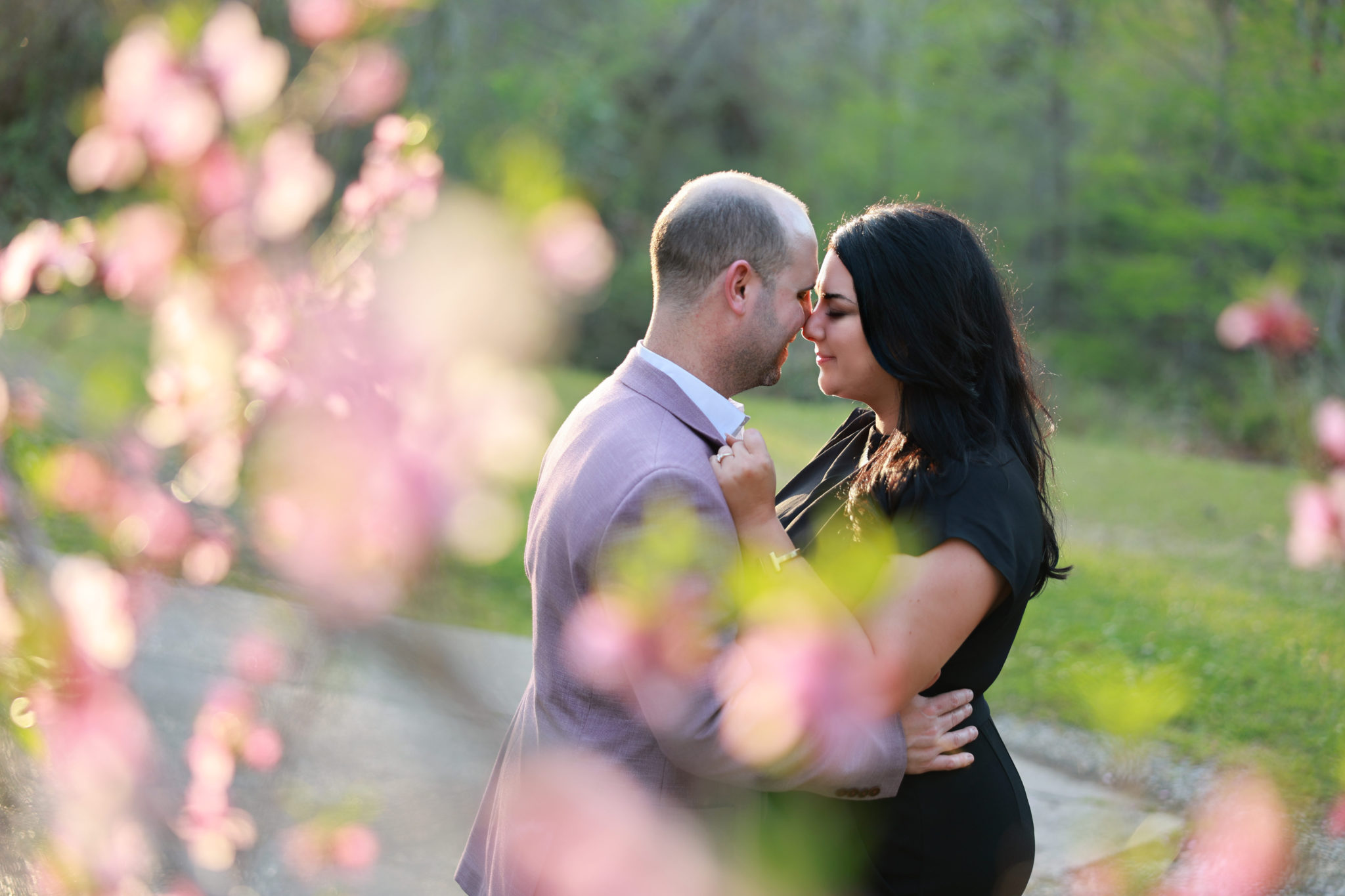 Rehearsal Dinner at Annadele's in Covington LA of bride and groom outside near cherry blossom