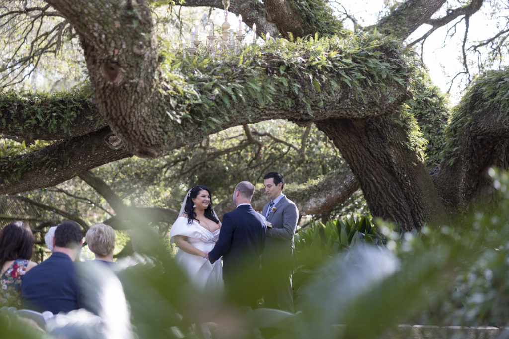 A serene moment between the bride and groom during their wedding ceremony under a huge tree during their Southern wedding outdoors in Covington LA
