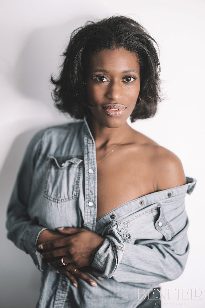 Denim Photo Session of beautiful black female model baring her shoulder and no bra looking at camera