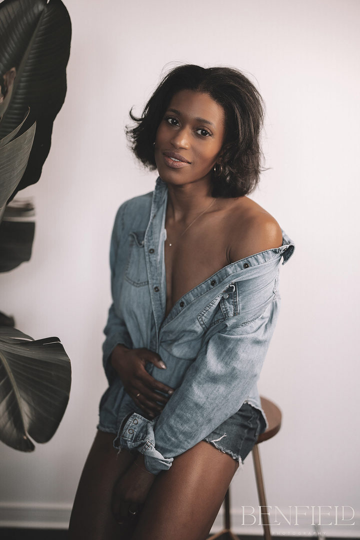 Denim Photo Session of beautiful black female model baring her shoulder and no bra looking at camera