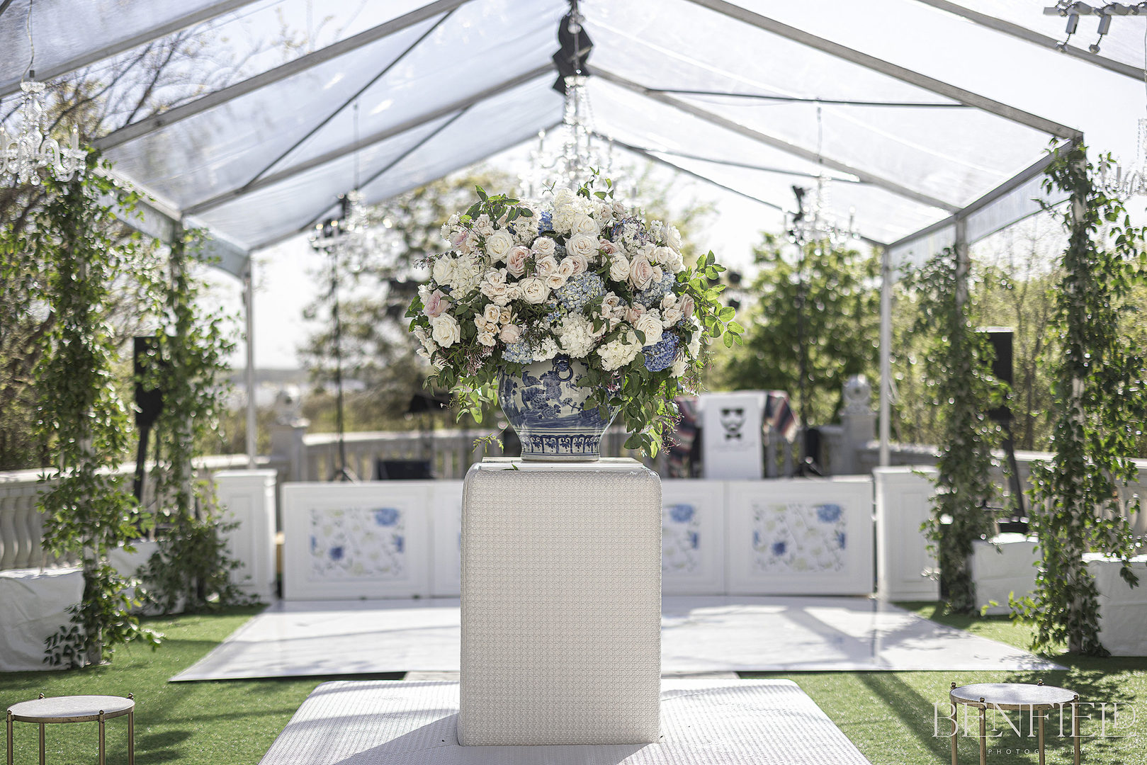 Huge floral arrangement under clear tent at wedding reception at Hillside Estate