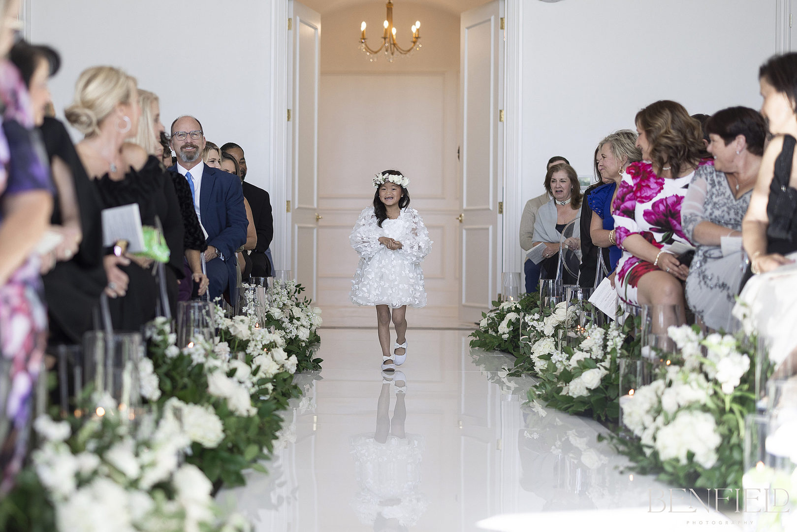 Beautiful flower girl walks down the aisle in preparation for the bride's entrance to her wedding ceremony at Hillside Estate