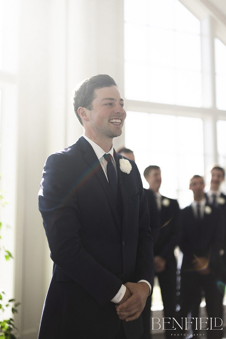 The moment when the groom first sees his bride as she enters the wedding ceremony at Hillside Estate's wedding chapel