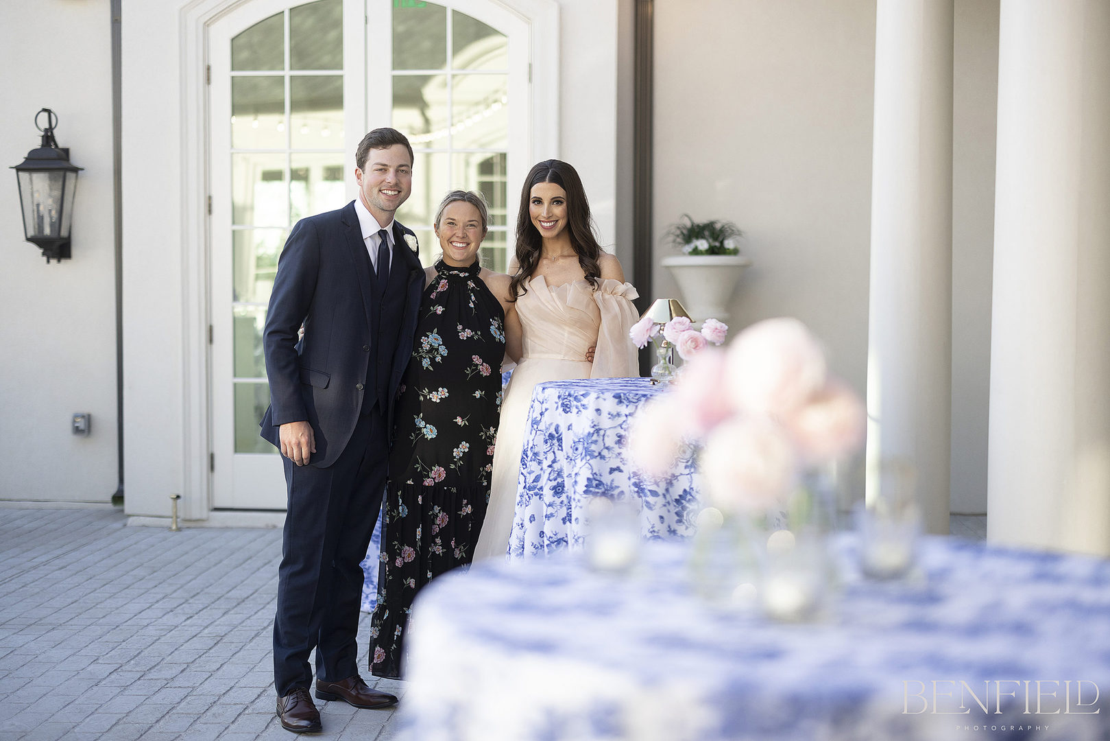 DFW Wedding Vendor Hunter Orcutt stands with the bride and groom at Hillside Estate on their wedding day.