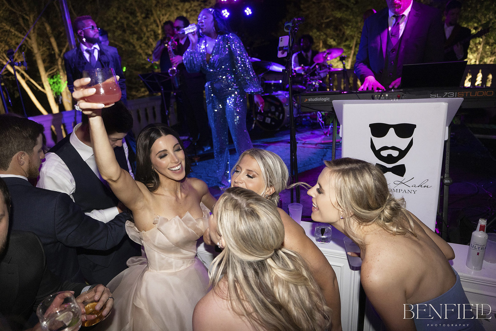 The bride dances with her bridesmaids to Jordan Kahn Music group during her wedding reception at Hillside Estate in Crossroads Texas
