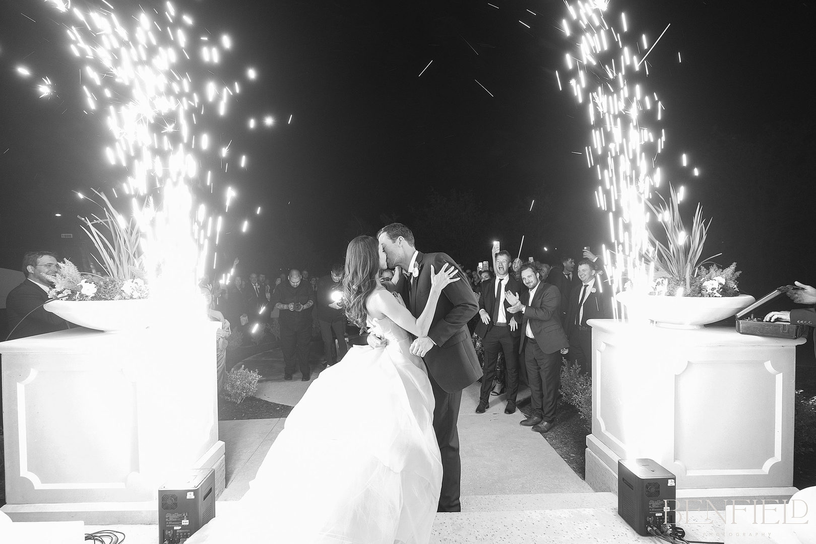 Bride and groom do a shower of cold sparkler exit getaway from their wedding reception.