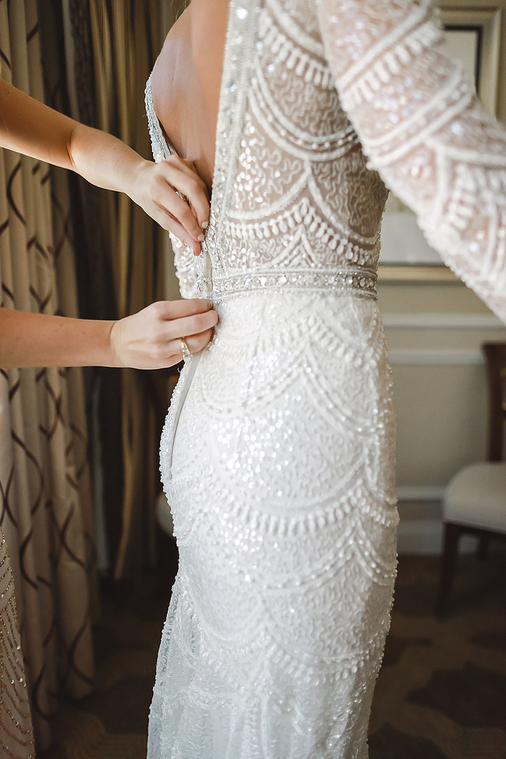 beautiful beaded berta bridal gown might be available for rent for your wedding, as seen her by the bride getting laced up for her wedding