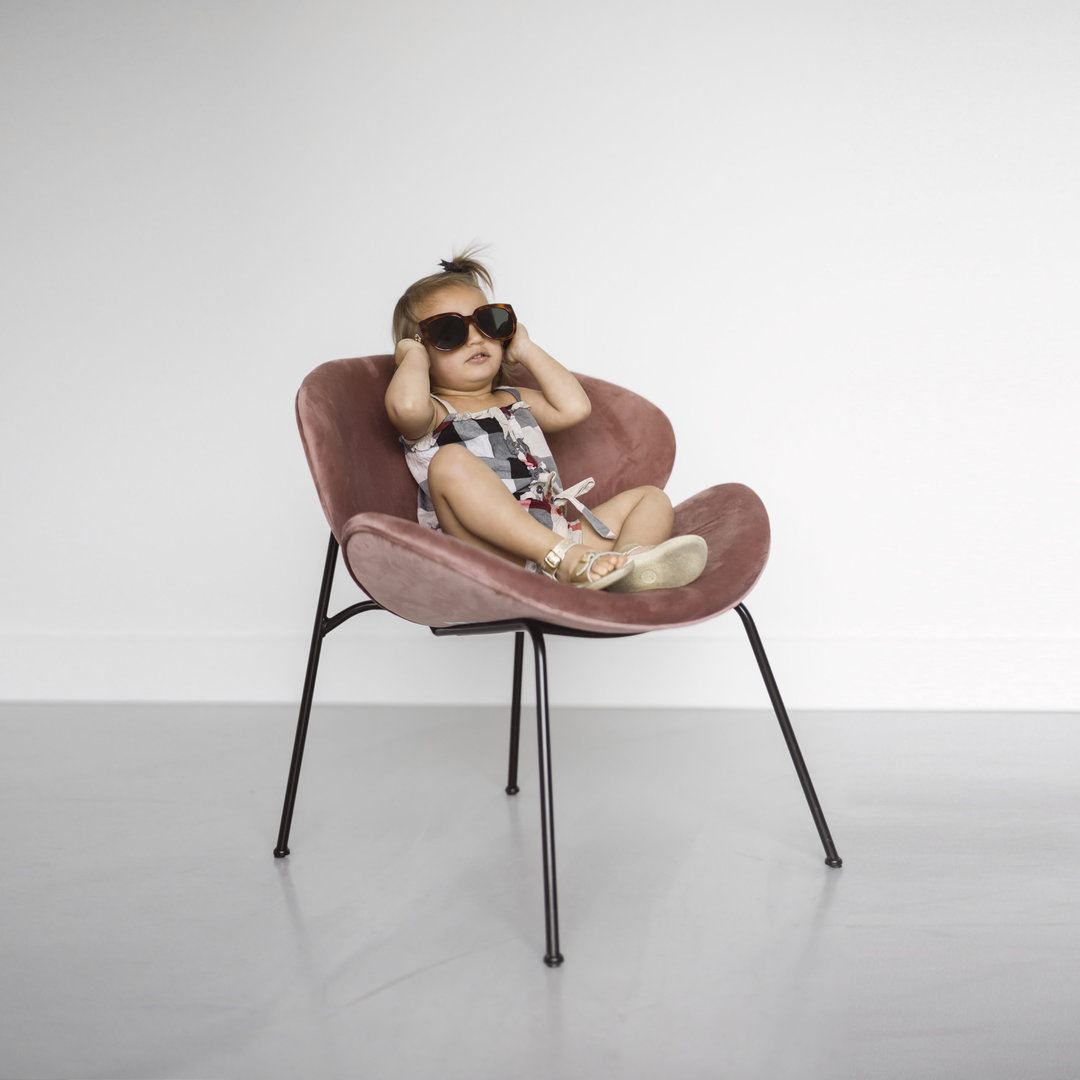 The Best Advice to Photograph Your Own Kids, shown by this toddler girl in burberry romper and gucci sunglasses
