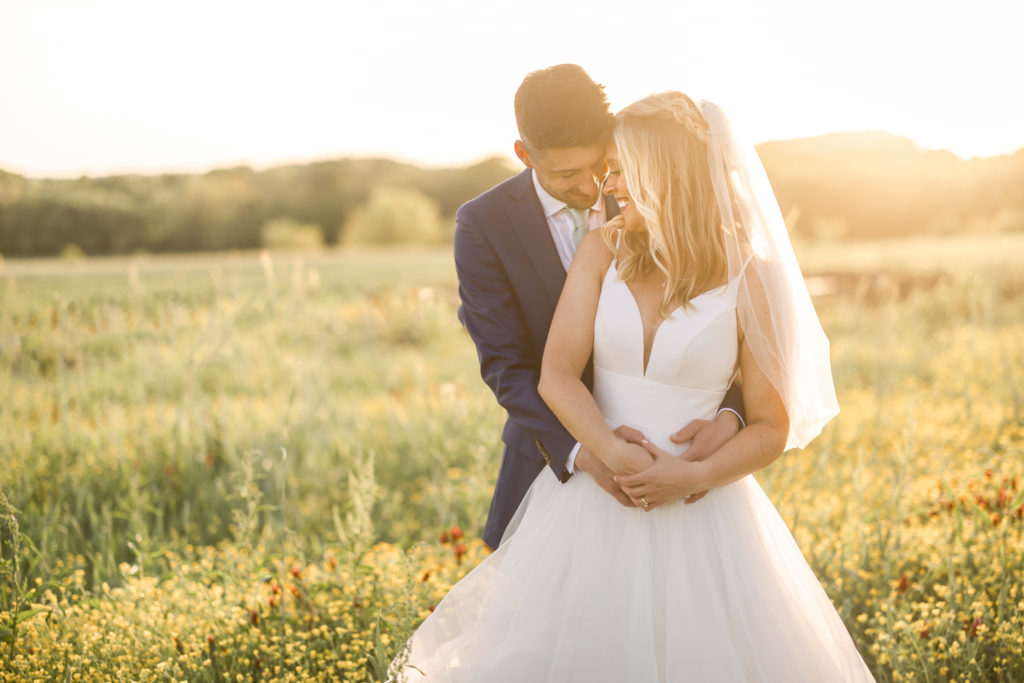 Warm and backlit timeless Wedding Portraits at Allenbrook Farms during golden hour as the bride and groom softly kiss
