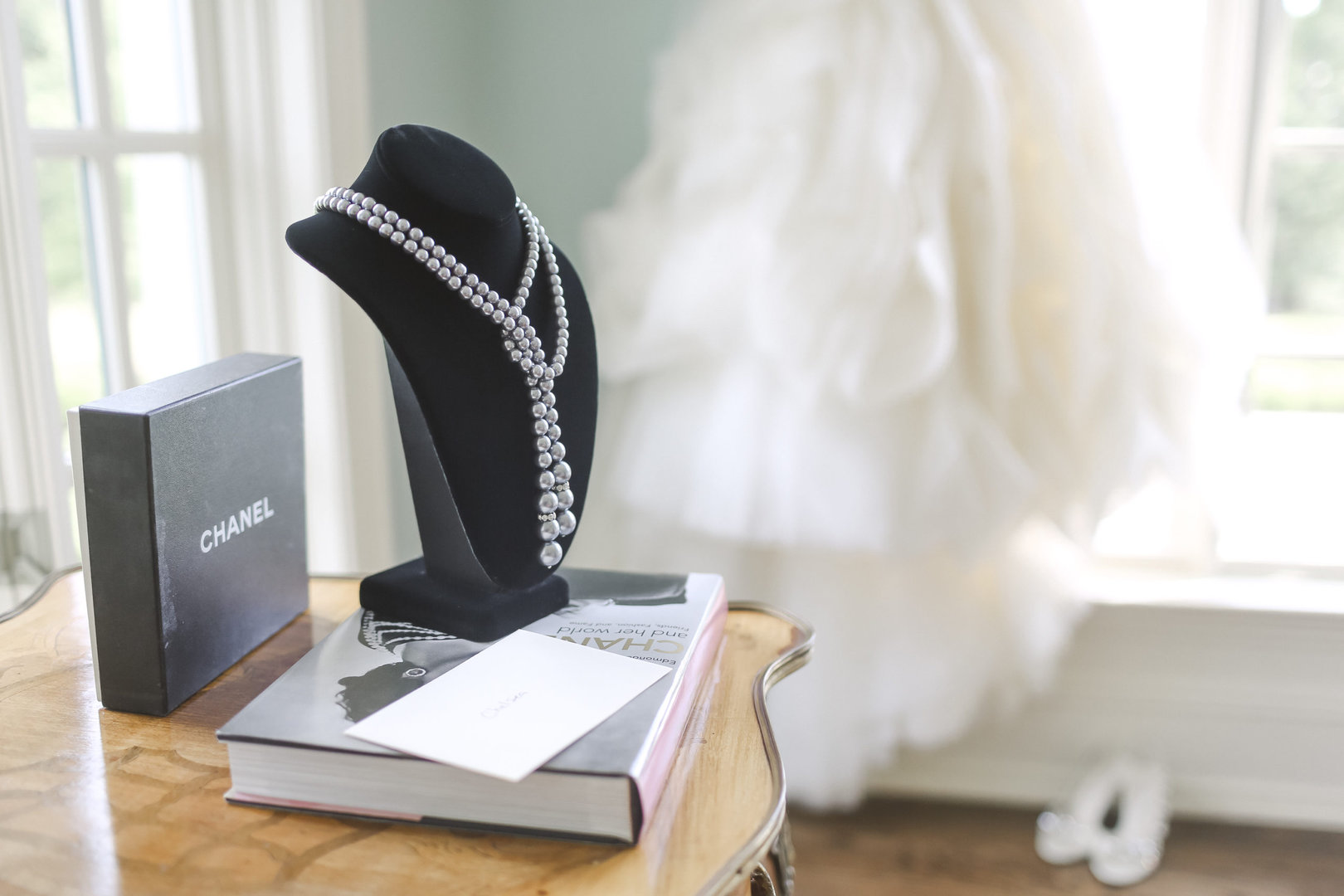 Luxury Estate Wedding Photography setup with a designer gown, vintage chanel necklace as a wedding gift for the bride