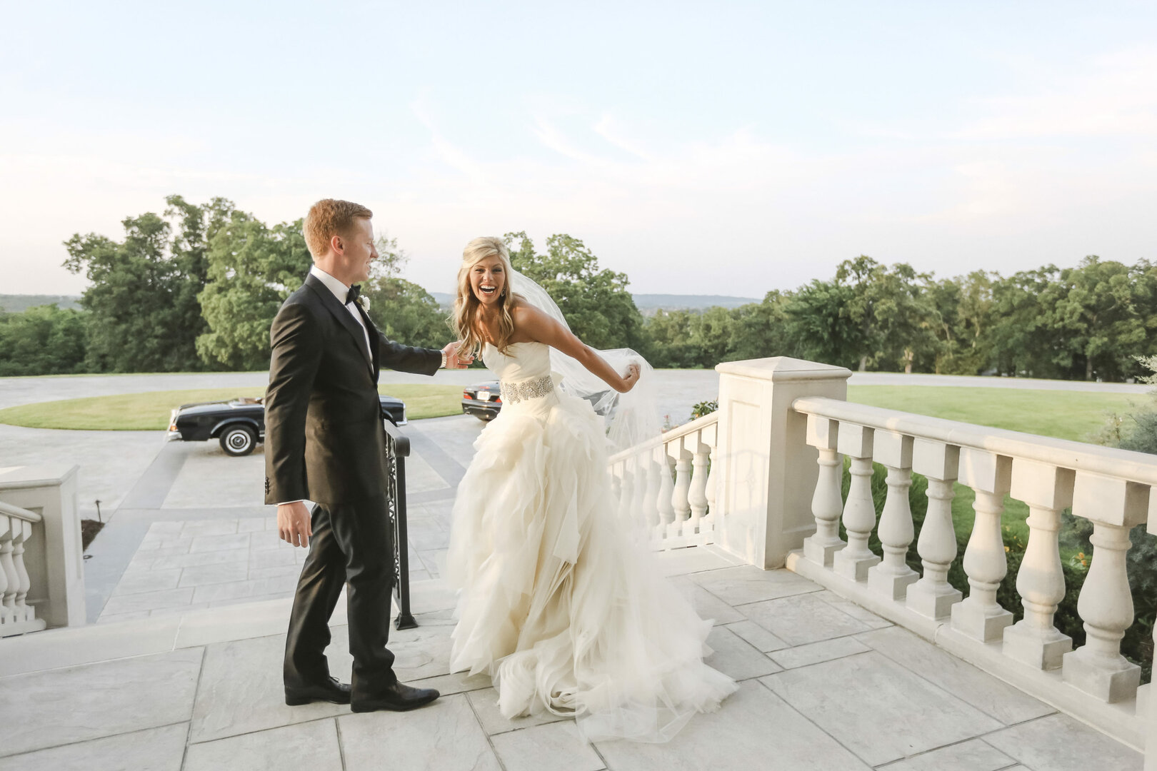 luxury wedding at private estate with high end photographer after the wedding ceremony on the front steps with a vintage mercedes benz in the background