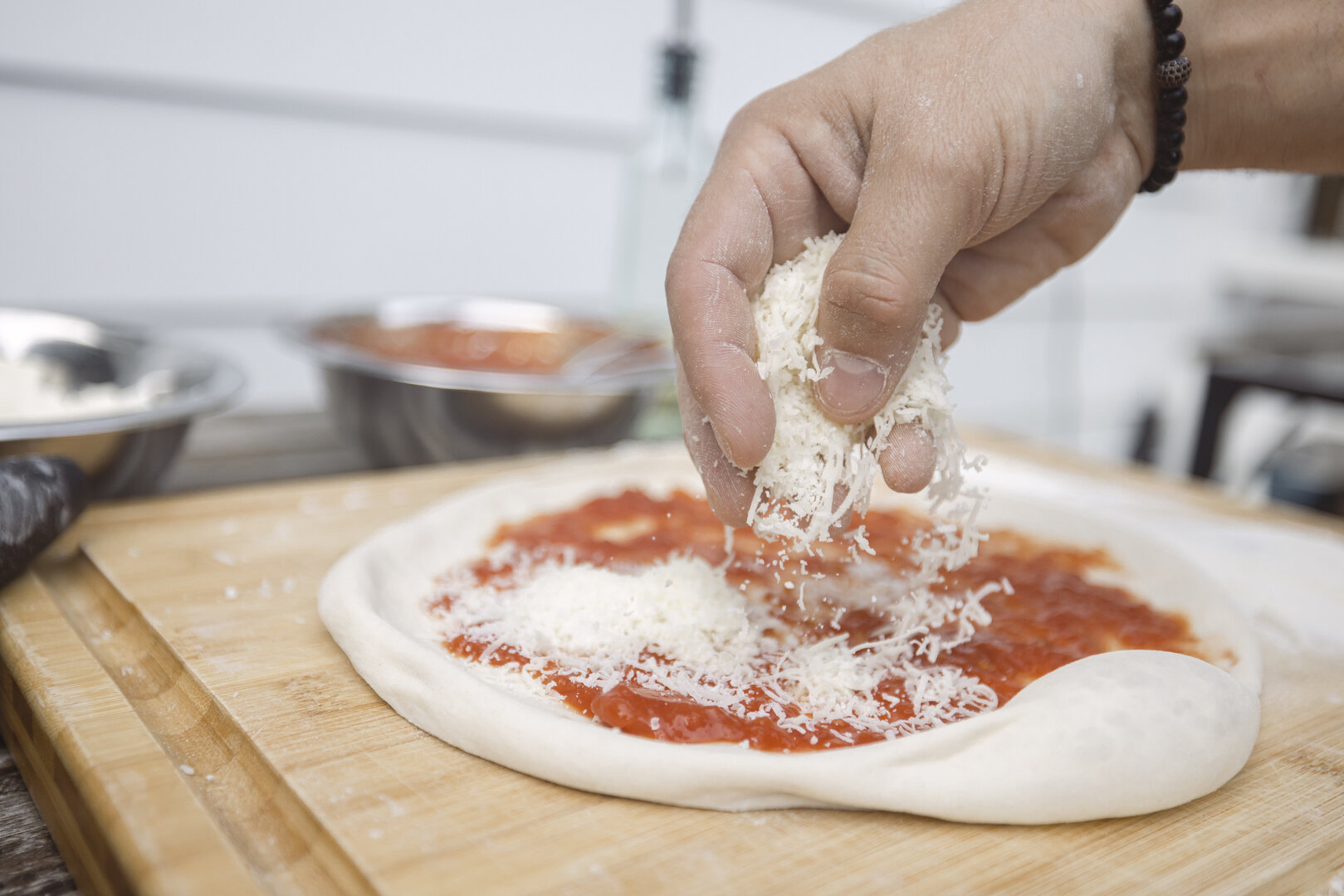 how to take great food photos for pizza party night by shooting pizza chef add grated cheese to pizza crust