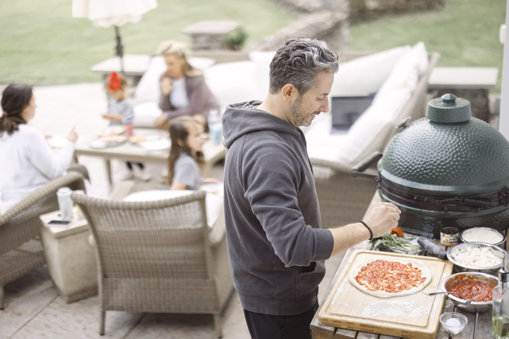 how to take great food photos for pizza party night by shooting the pizza chef cooking the pizza in the ooni outdoor pizza oven