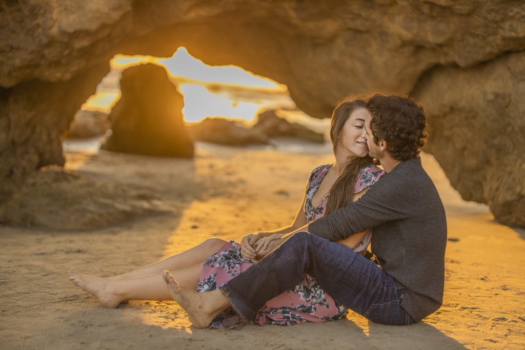 Engagement Portraits in Malibu at sunset with couple kissing