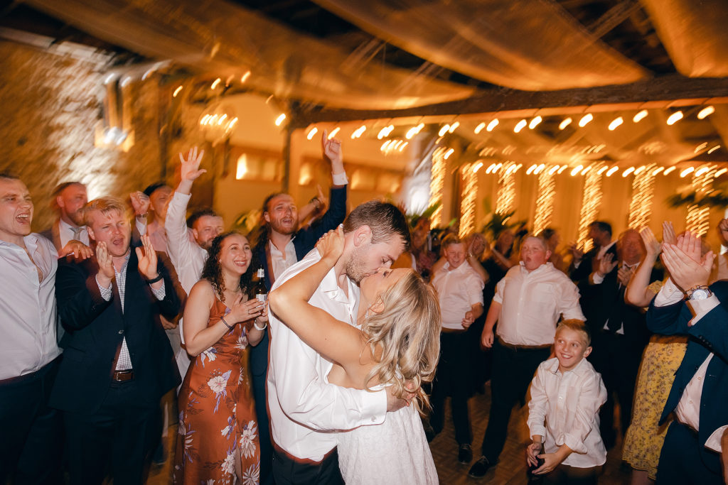 bride and groom kiss on the dancefloor at the Hamp Williams reception venue in Hot Springs during their wedding reception.