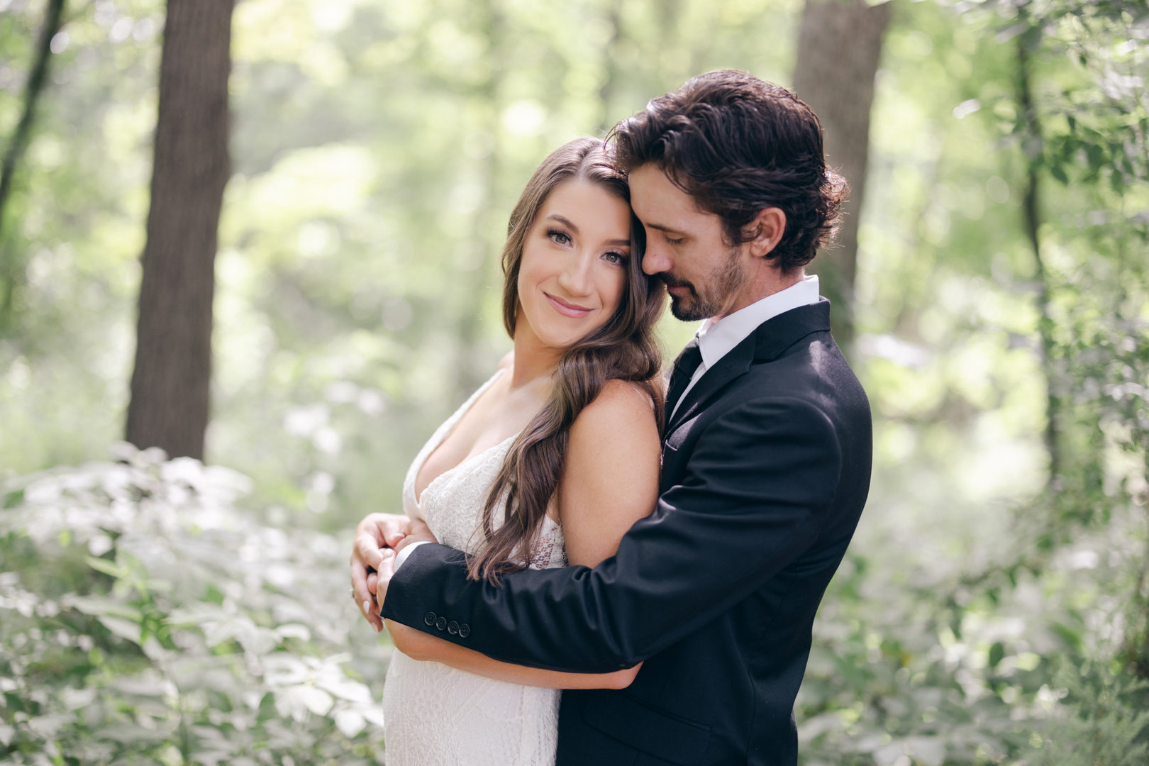 bride and groom portraits from their wedding at Kindred North by NWA Wedding Photography Benfield Photography out in the woods surrounding the centerton wedding venue.
