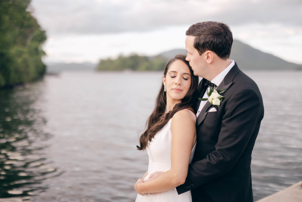 Wedding portraits of the bride and groom at The Sagamore with Lake George behind the couple.