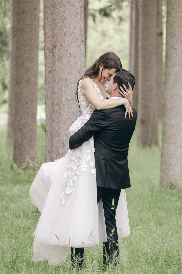bride and groom kissing in the forest tall trees outside the Hall of Springs in Saratoga NY