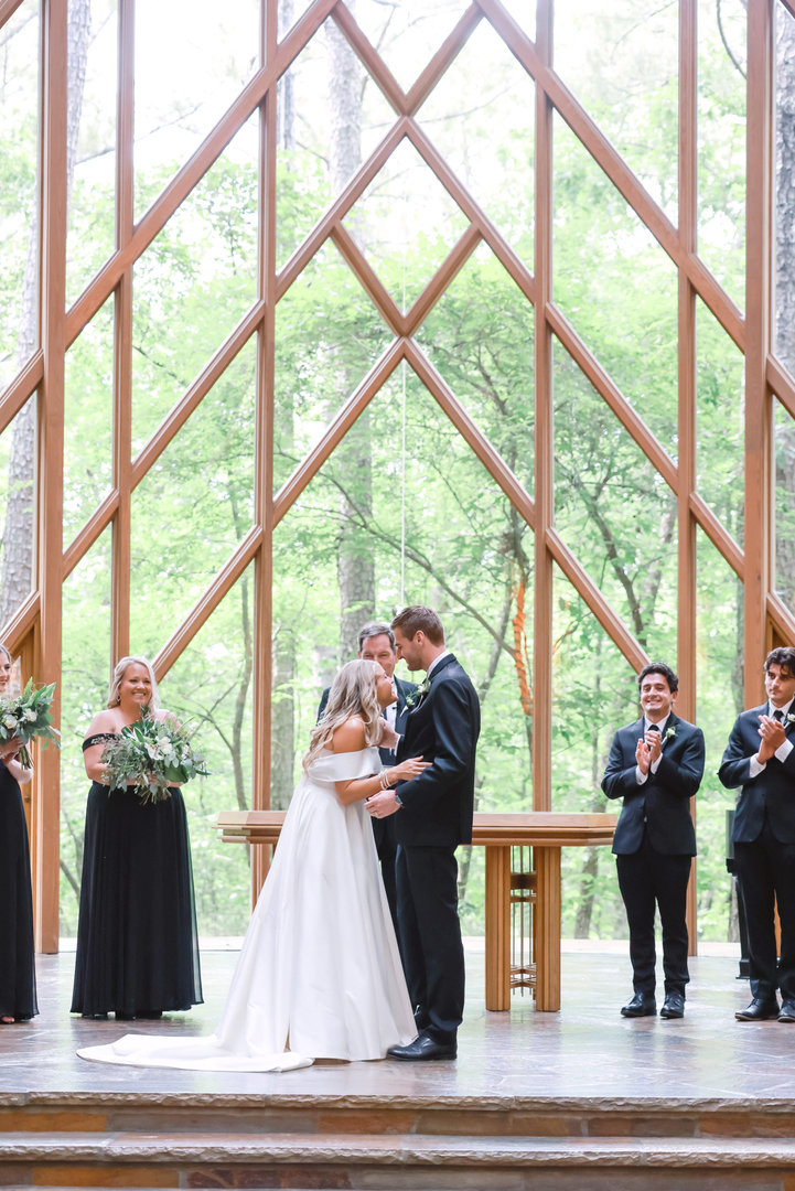 bride and groom laughing during ceremony at anthony glass chapel at garvan gardens in hot springs arkansas