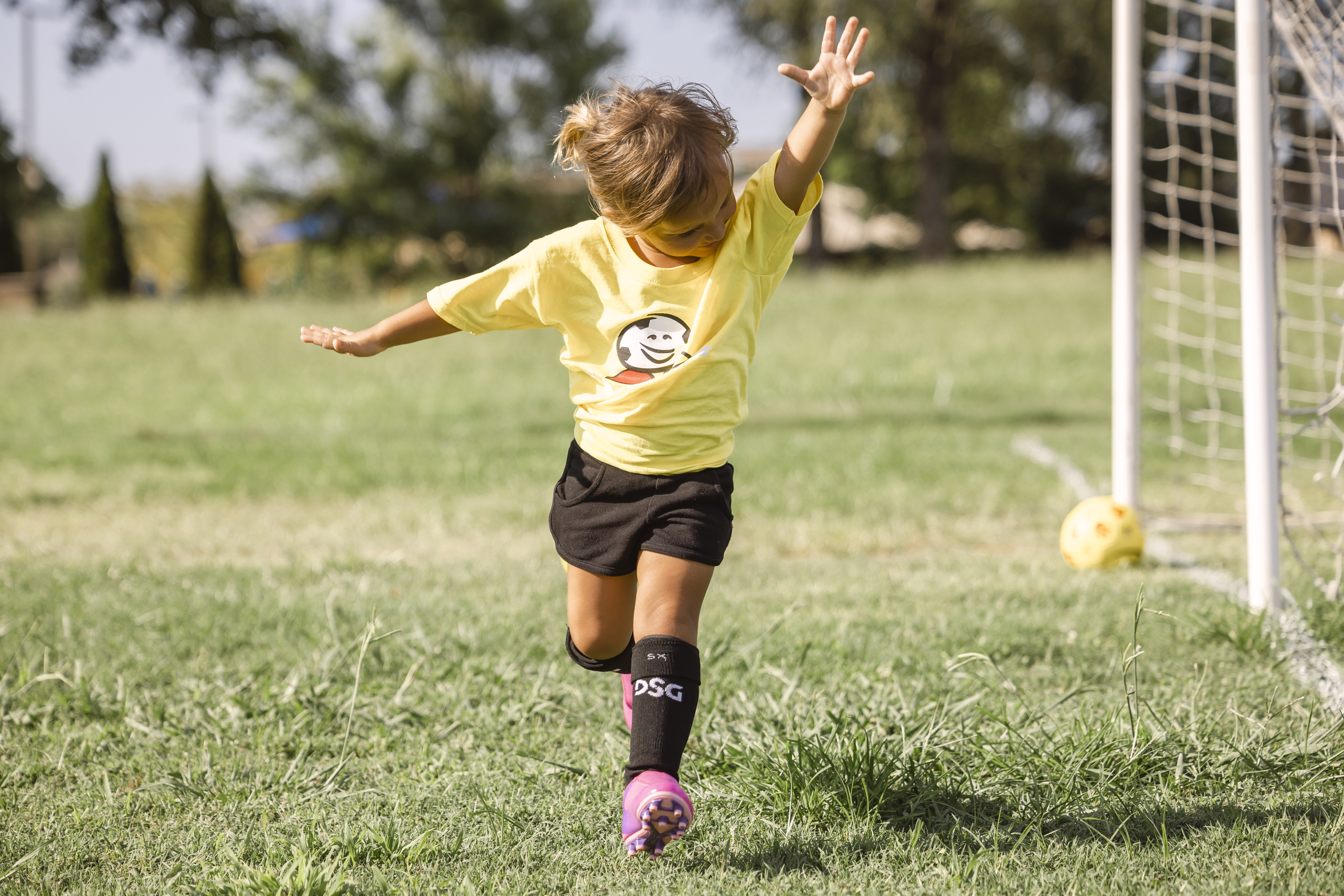 2 year old girl kid celebrates after scoring her first goal in soccer