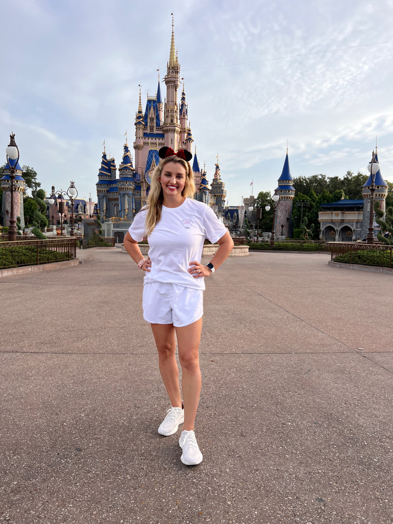 Tyler Benfield standing in front of Cinderella's castle at Disney World