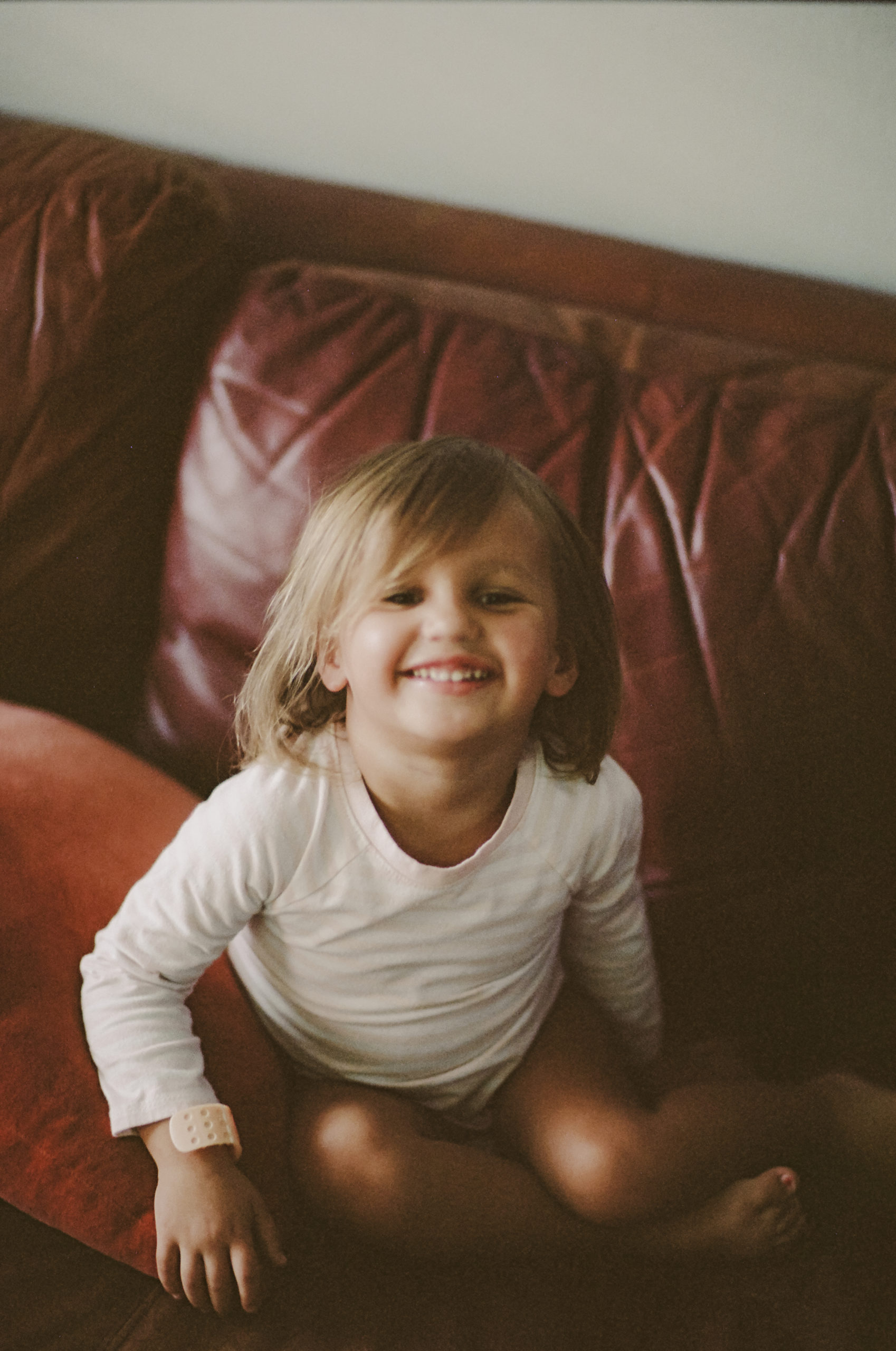 is film dead? nope, not according to this shot of a little girl sitting on a leather couch in the living room