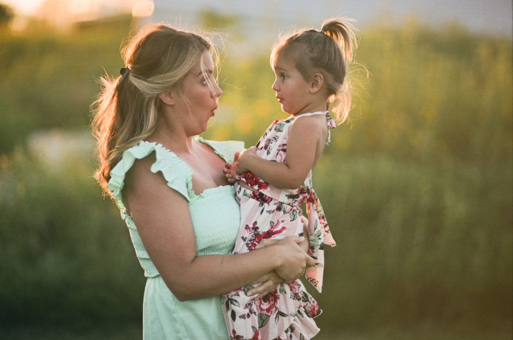 family photo shoot on film of a mom and daughter at golden hour sunset