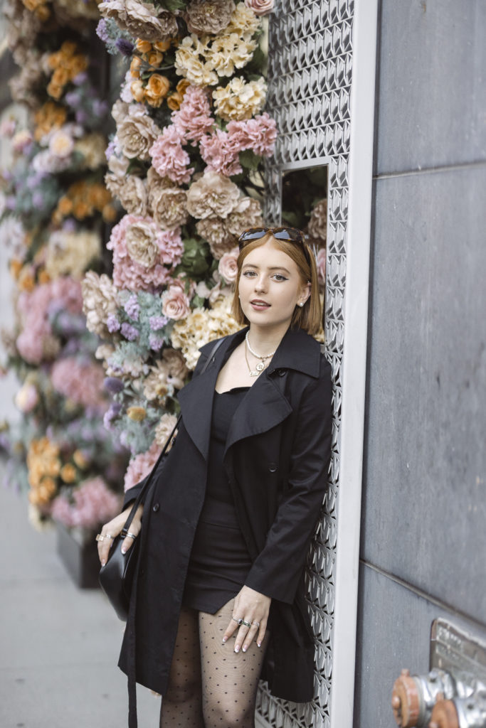 street style senior pictures in NYC in front of a flower wall