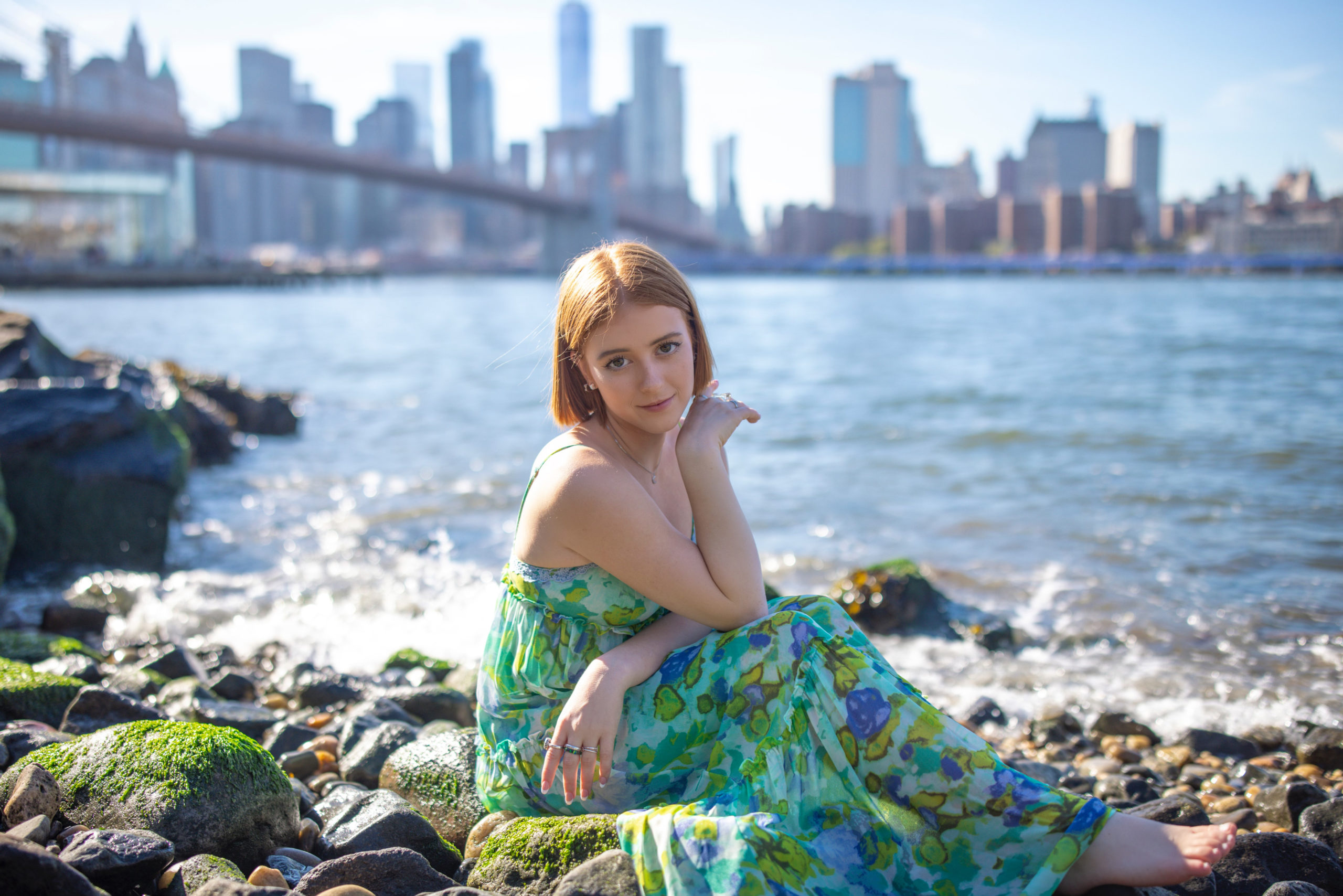 NYC senior photos in the Hudson River of a girl in a green flowy dress.