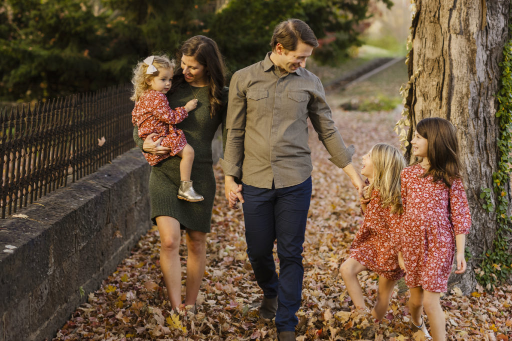 Fall Mini Session in NWA for George Family walking through autumn leaves