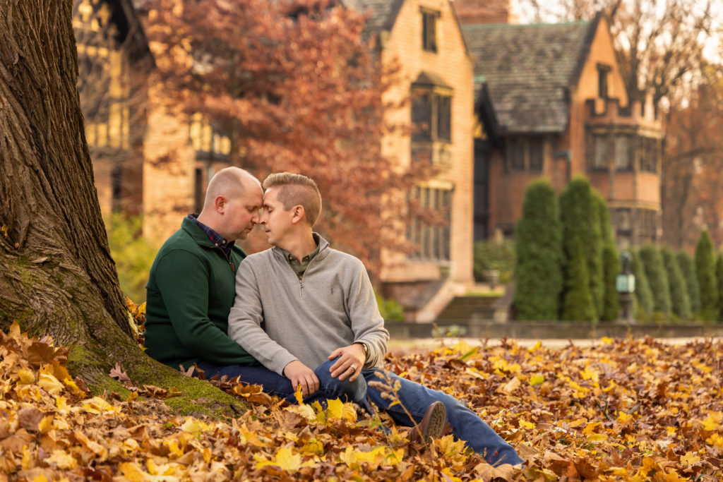 Engagement pictures at Stan Hywet of same sex gay couple in the gardens with the hall in the background.