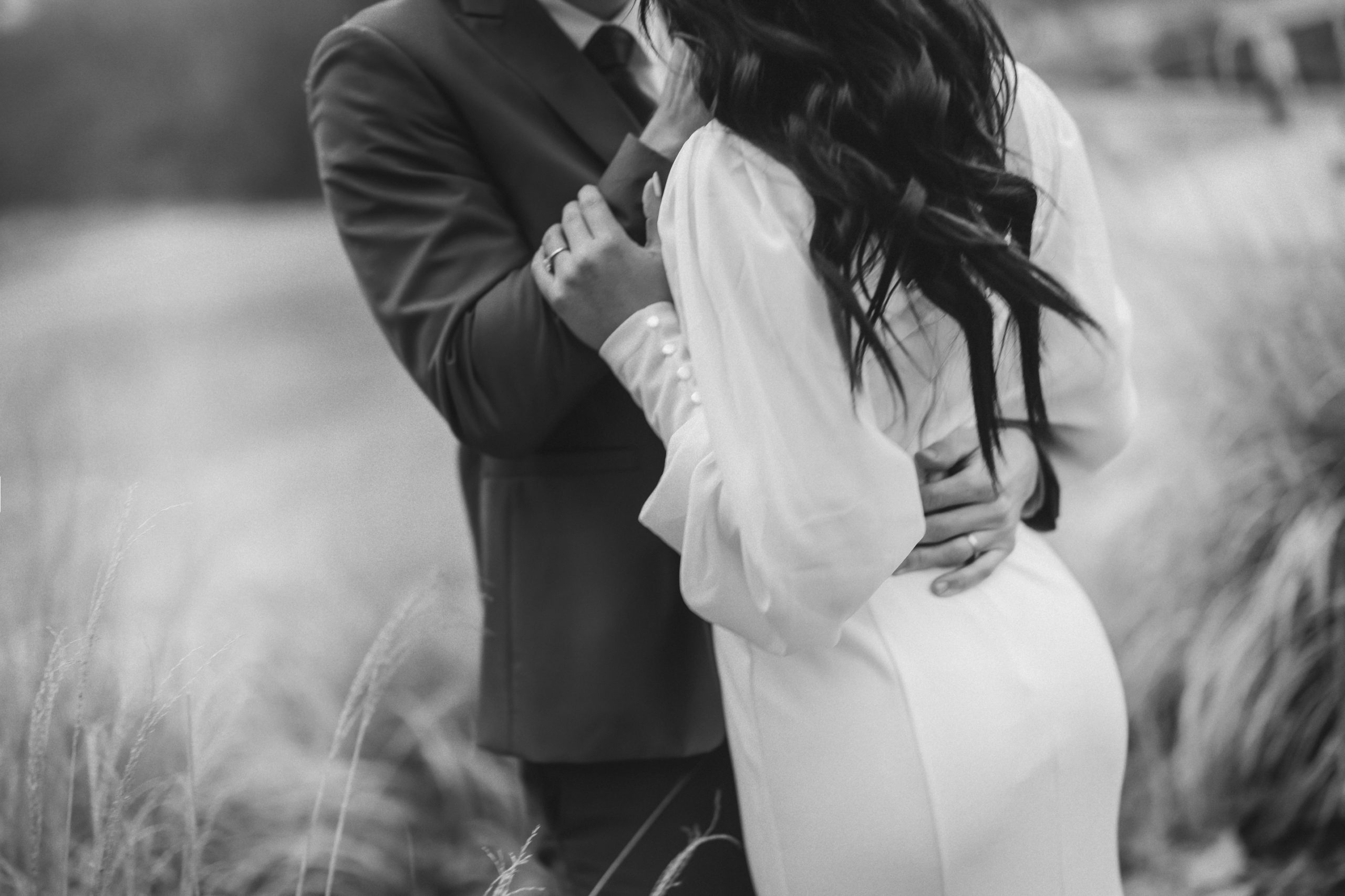 Timeless B+W Wedding Portraits of a bride and groom in a field