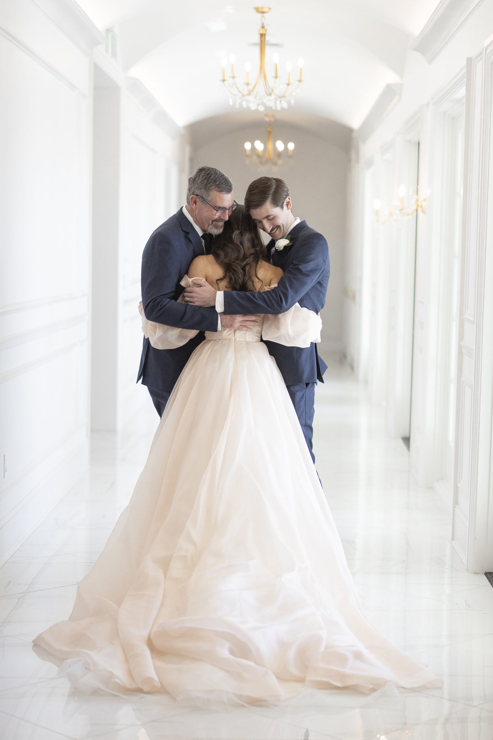 Best wedding moments of 2022 of a bride sharing a first look with her father and brother at Hillside Estate in DFW