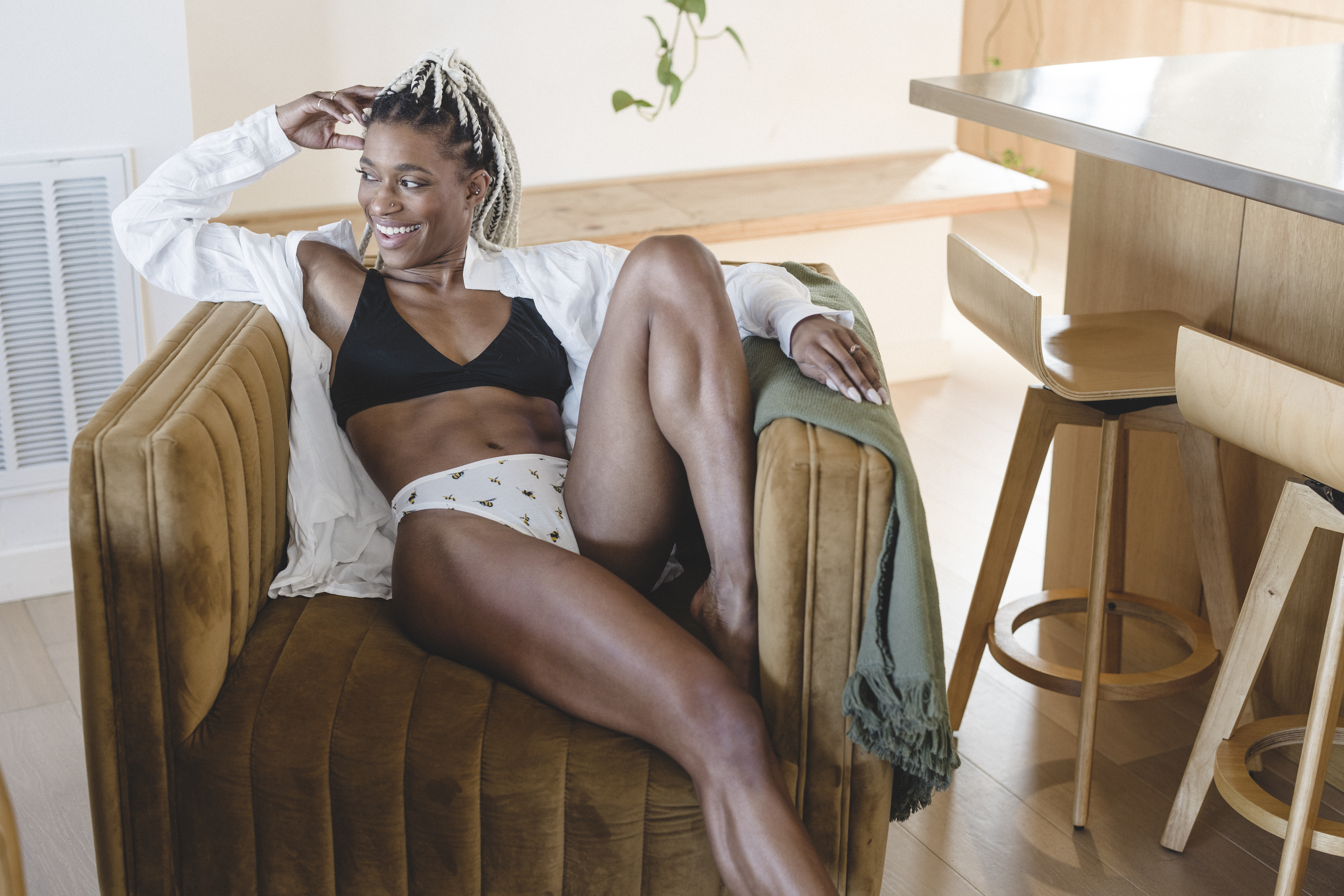 NWA boudoir photographer captures a beautiful african american female in mid-century modern living room
