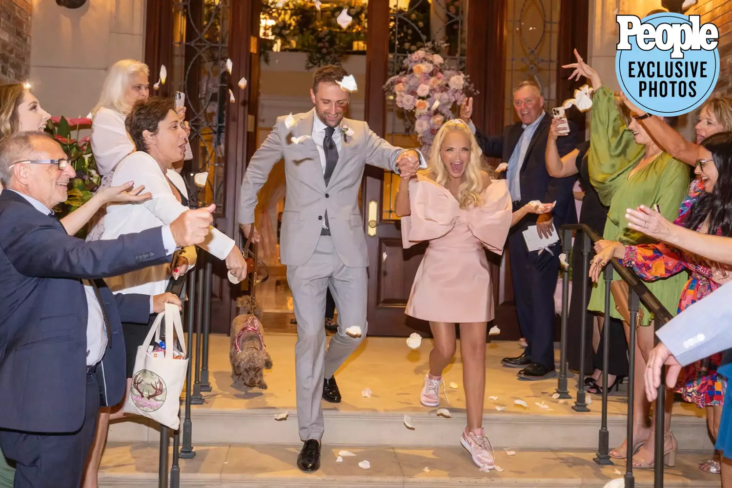 Kristin Chenoweth's wedding dress as she leaves her reception with husband Josh Bryant amidst guests throwing flower petals.
