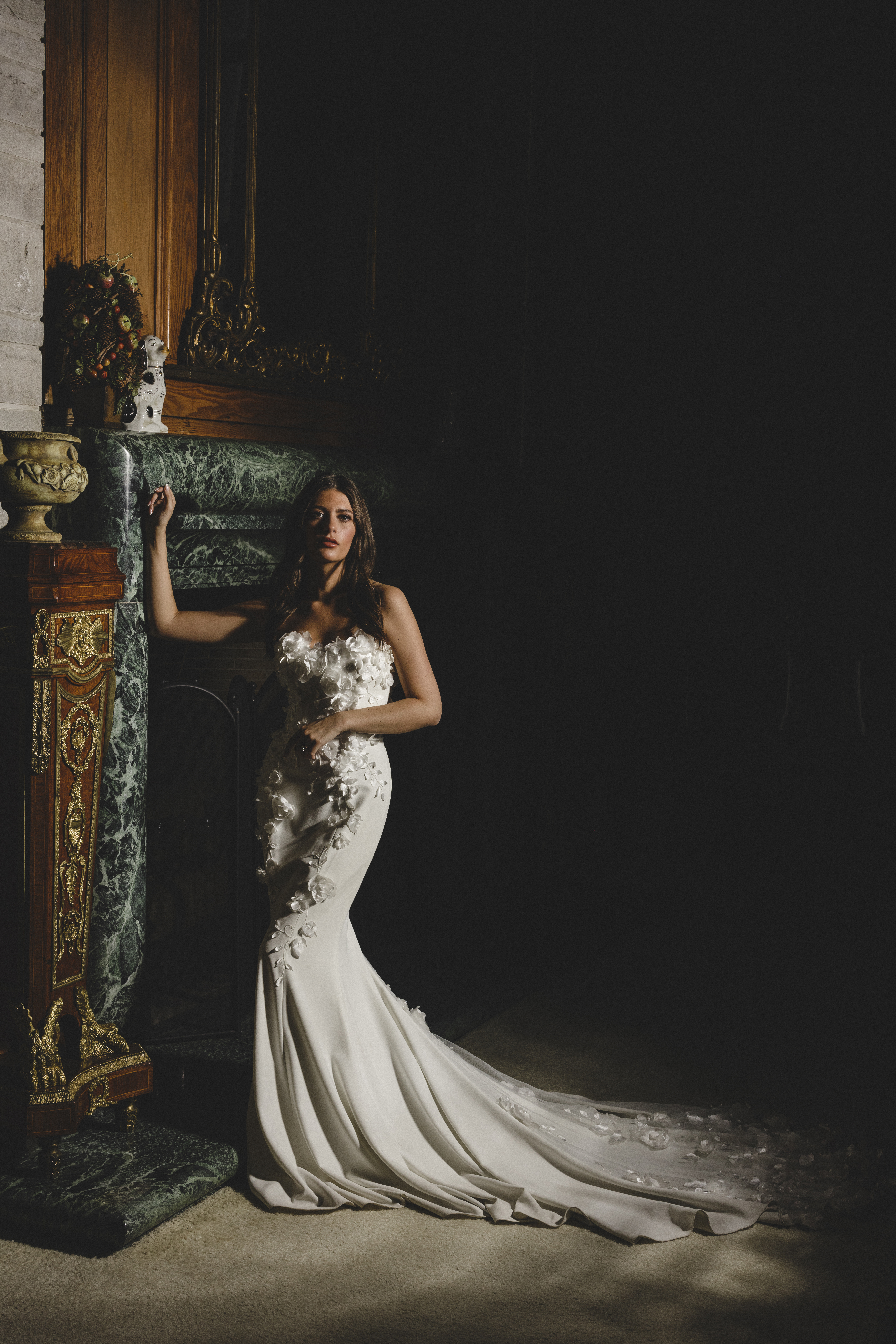 bride standing by luxury fireplace in a luxury dress at for the styled Wedding at Greystone Estate.