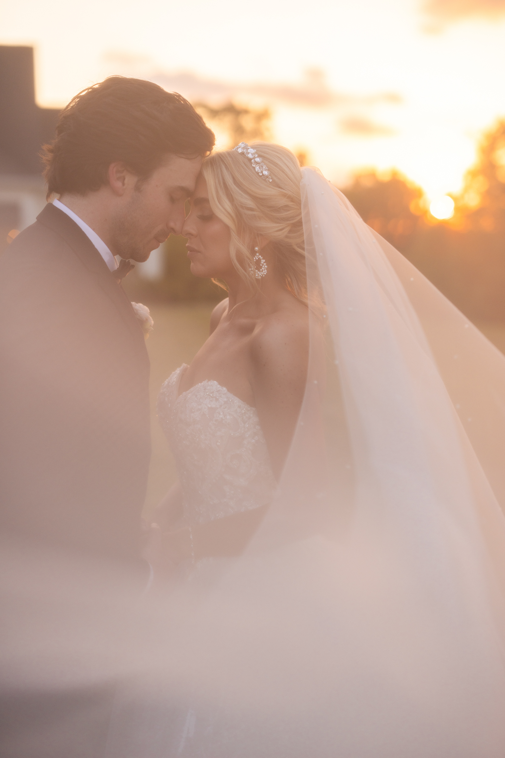 Bride and groom during a golden hour sunset at Castle Hill wedding venue in Oxford MS