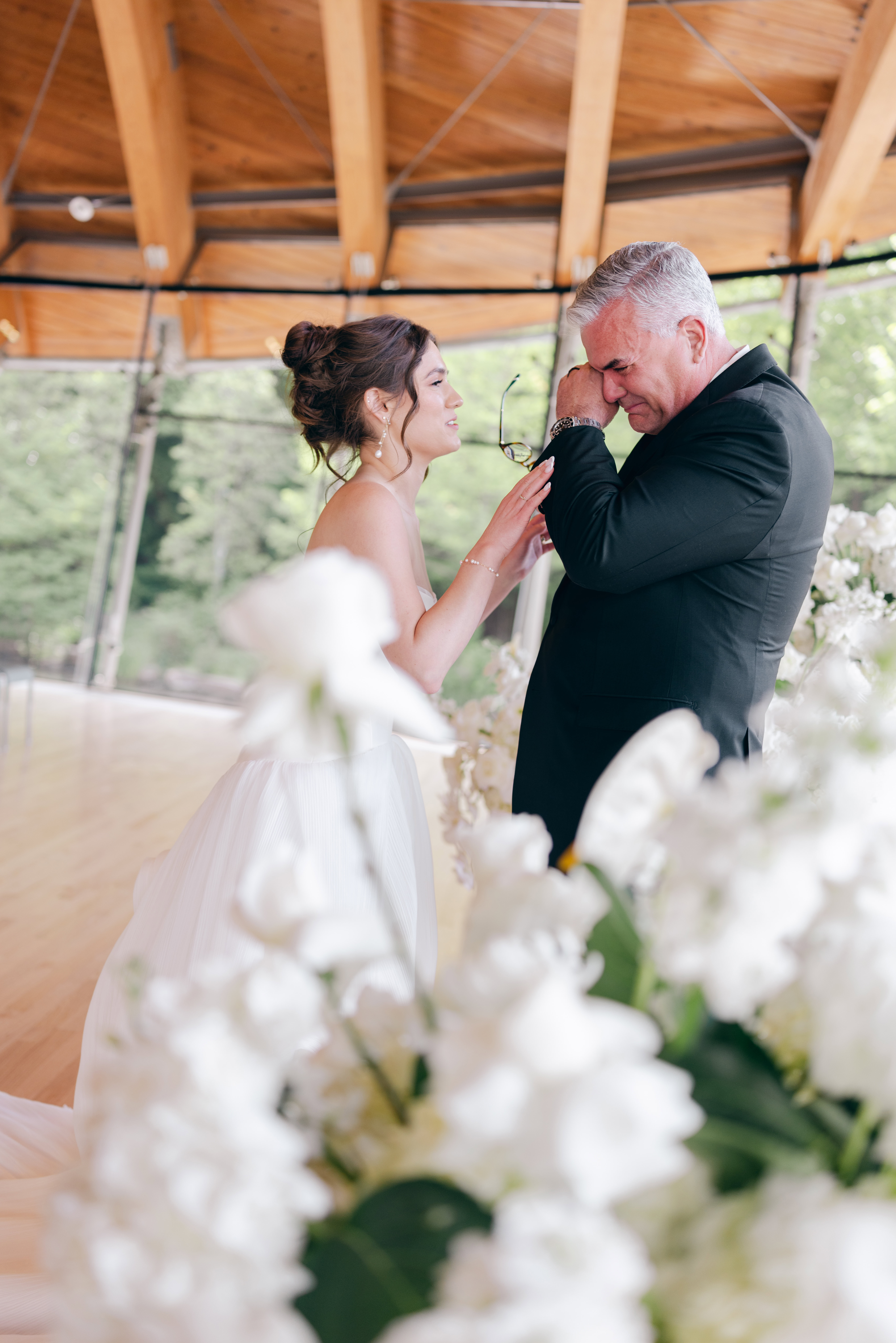 A bride's dad cries as he sees the bride for the first time in her wedding dress before her Crystal Bridges wedding.