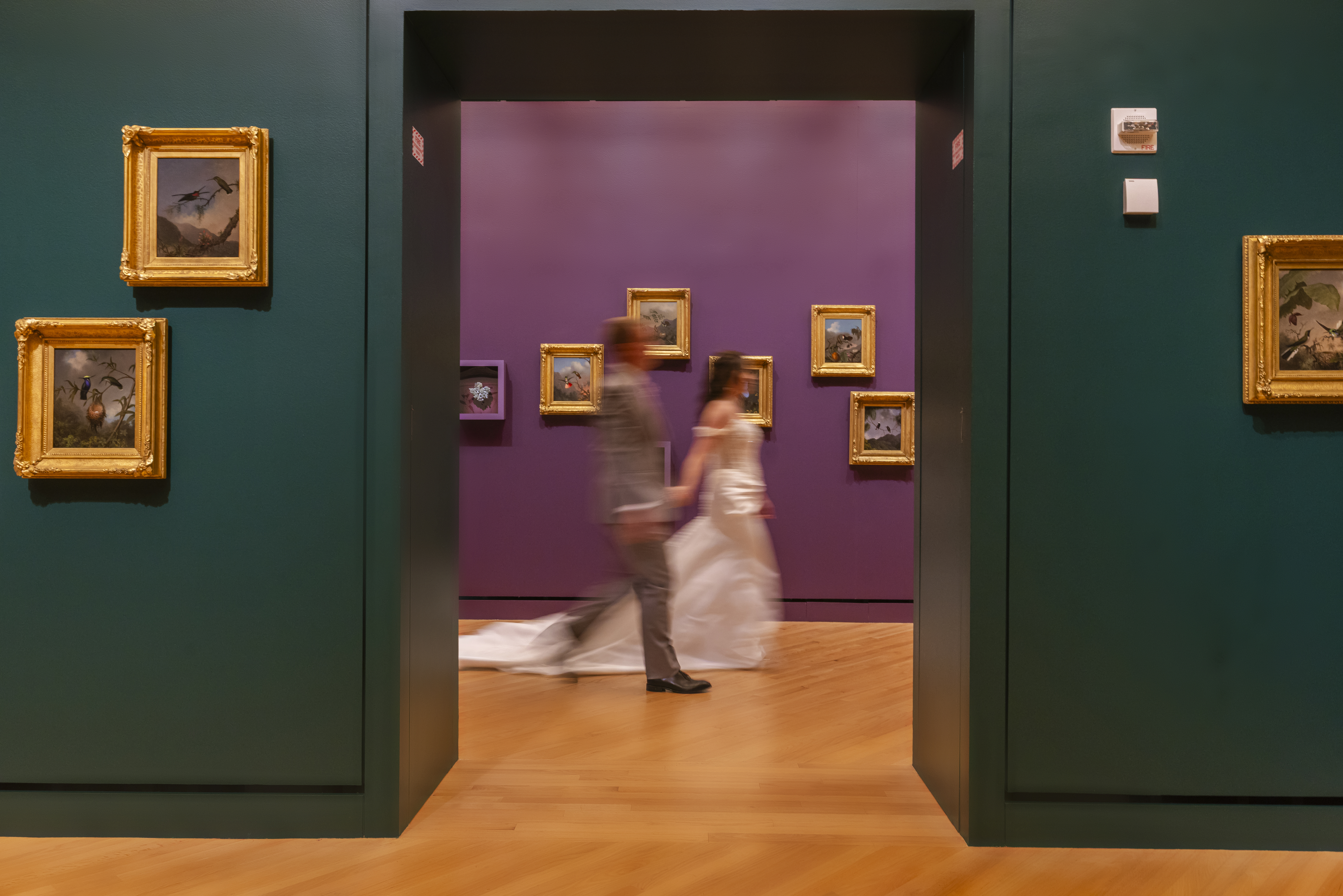 creative wedding portrait at Crystal Bridges Museum with bride and groom motion blur in gallery doorway